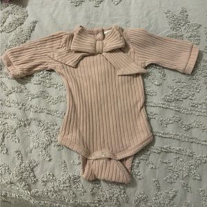 Kate Quinn soft pink organic cotton wide rib bow front bodysuit onesie